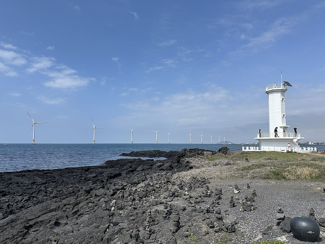 Sinchang Windmill Coastal Road with wind turbines along the sea, Jeju Island