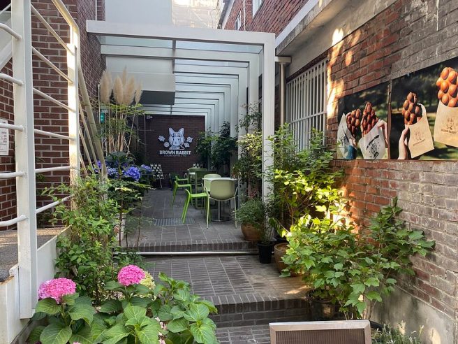 Flowery cafe storefront in Seongsu-dong, Seoul, part of the neighborhood's warehouse cafe culture
